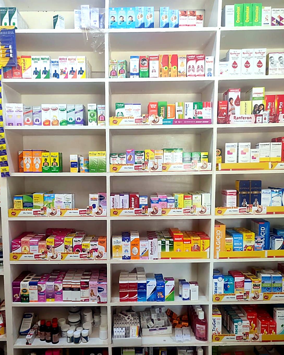 Well-stocked medicine shelves at the Amla Medicare pharmacy